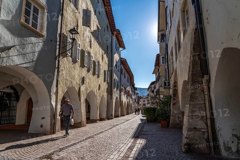 The town of Neumarkt, in the Adige Valley, in South Tyrol, arcades in the old town centre, in front of the shops and restaurants, Italy, Europe