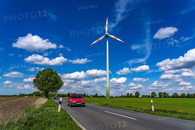 Wind turbine, wind energy plant from the manufacturer Enercon, blue sky with many white clouds, near Schermbeck, country road, Bestener StraÃŸe, North Rhine-Westphalia, Germany, Europe