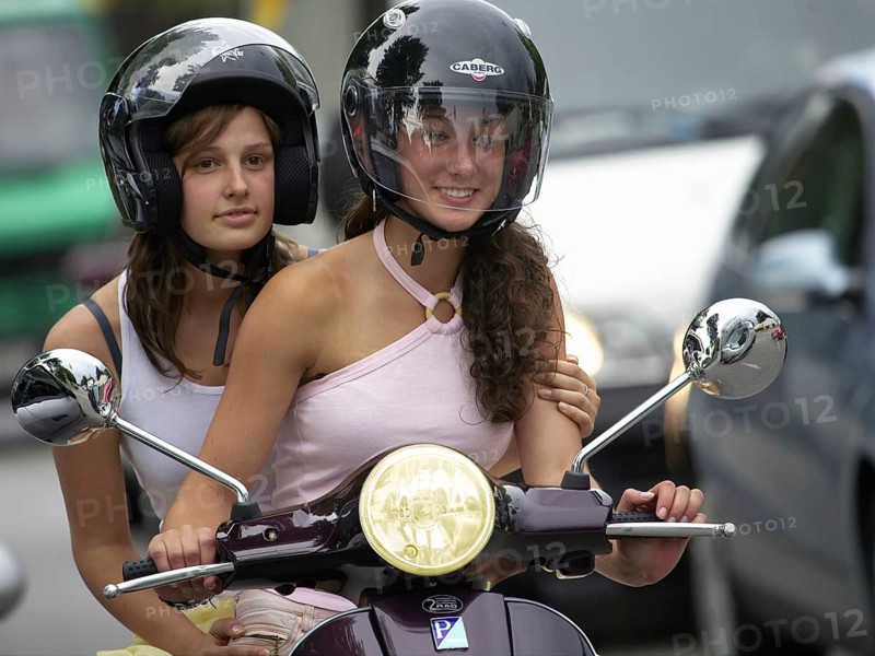 Two woman riding a scooter, Barcelona, Spaina
