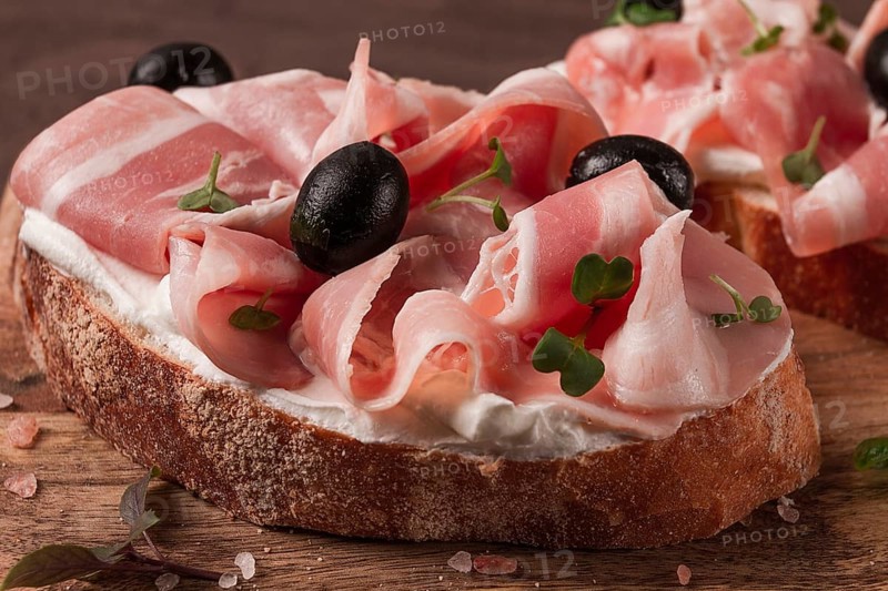 Breakfast, bacon and olives sandwich, on a cutting board, top view, close-up, no people