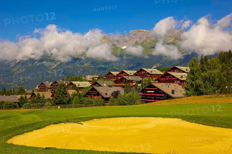 Crans Sur Sierre Golf Course with House and Mountain View in Crans Montana in Valais, Switzerland, Europe
