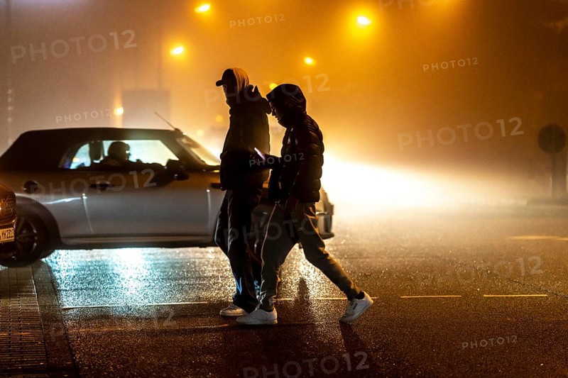 Pedestrian, darkness, city centre traffic, Rüttenscheider StraÃŸe, pedestrian crossing, traffic light, fog, autumn, winter, Essen, North Rhine-Westphalia, Germany, Europe