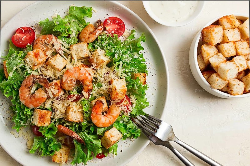 Caesar salad, with shrimp, on a white background, homemade, no people