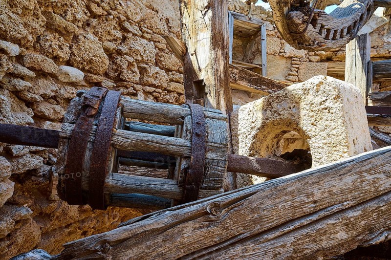 Close-up of an old wooden wheel in a dilapidated stone structure, windmill, ruin, near Lindos, Lindos, Rhodes, Dodecanese, Greek Islands, Greece, Europe