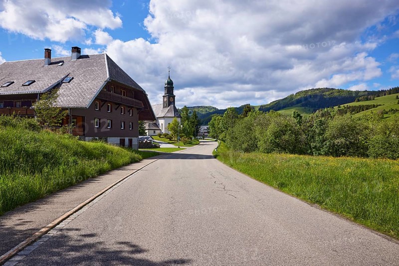 Street with Black Forest house and the church of St. Johann in the Innerlehen district, Bernau im Black Forest, Black Forest, Waldshut district, Baden-Württemberg, Germany, Europe