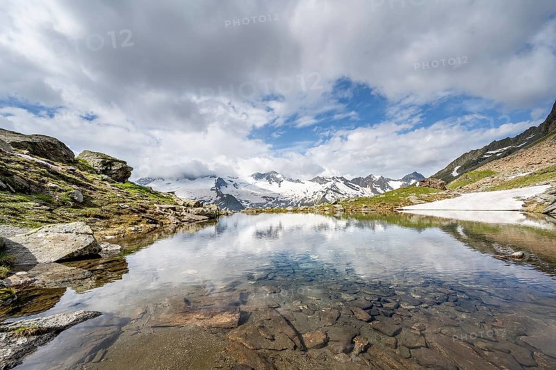 Picturesque mountain landscape with mountain lake, mountains and glaciers reflected in the Schwarzsee, Hornkees and Waxeggkees glaciers with GroÃŸer Möseler peak, Berliner Höhenweg, Zillertal Alps, Tyrol, Austria, Europe