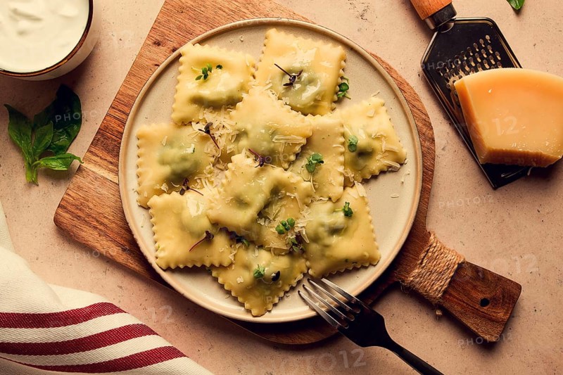 Ravioli with spinach and cheese, vegetarian food, on a beige background, no people.selective focus, rustic