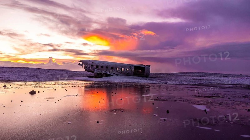 Beautiful aerial drone view at sunrise on crashed plane on frozen Solheimasandur beach in winter, Iceland, Europe