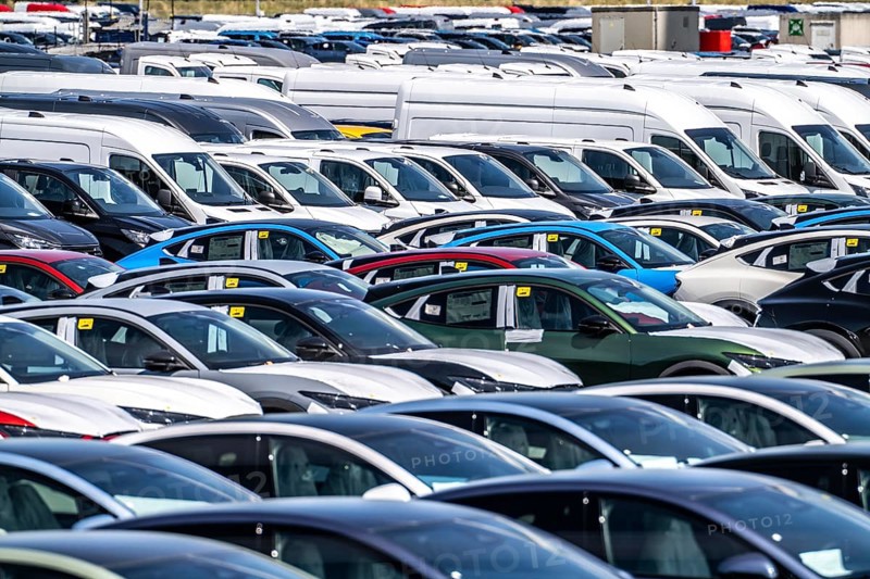 Storage area for new cars in the port of Vlissingen-Oost, vehicles are temporarily stored on over 100 hectares to ship them from Europe to the United Kingdom, Ford cars, others such as models from the Chinese car manufacturer BYD are delivered from here in Europe, wind farm, Netherlands