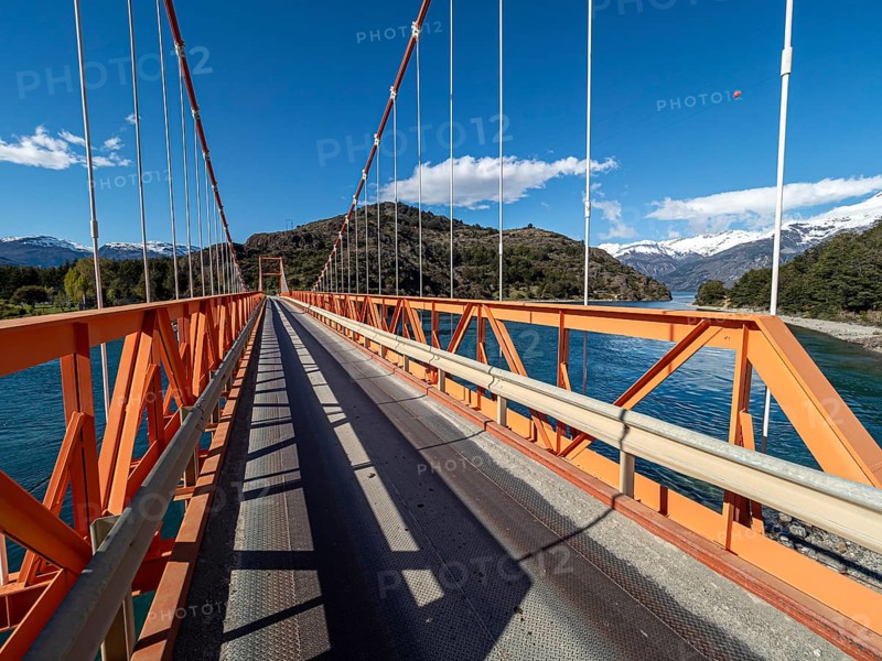 Wideangle view of famous orange suspension bridge Puente General Carrera, at lake Lago General Carrera, Patagonia, Chile, South America