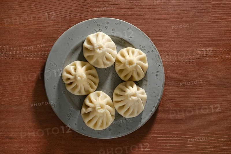 Overhead view of a plate with traditional Georgian dish khinkali stuffed with lamb of beef meat