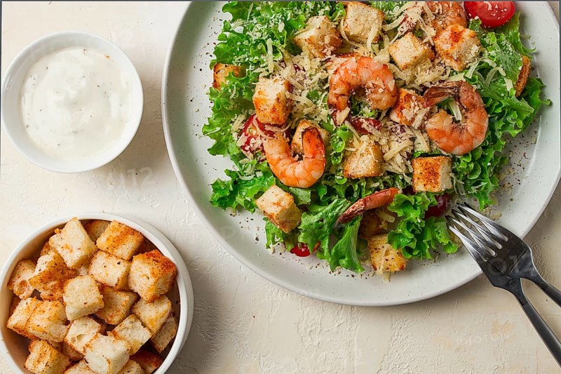 Caesar salad, with shrimp, on a white background, homemade, no people