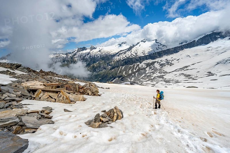 Mountaineer in a snowfield, descent from the summit of the Schönbichler Horn, view of snow-covered and glaciated mountain landscape, Berliner Höhenweg, Zillertal Alps, Tyrol, Austria, Europe