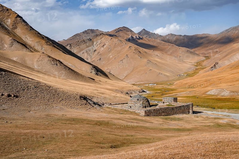 Historic caravanserai Tash Rabat from the 15th century, with yellow hills, Atbashy district in the Naryn region, Kyrgyzstan, Asia