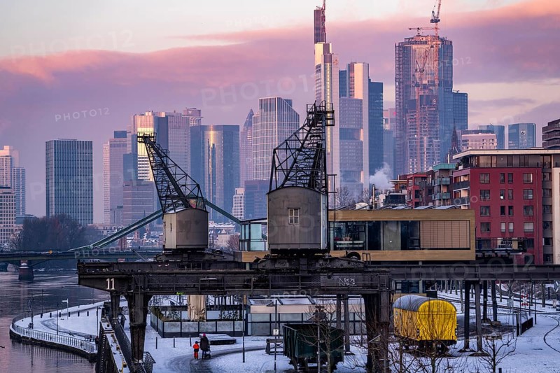 The skyline of Frankfurt am Main, skyscrapers of the banking district, historic harbour cranes at the Wesel shipyard, wintry morning, Hesse, Germany, Europe