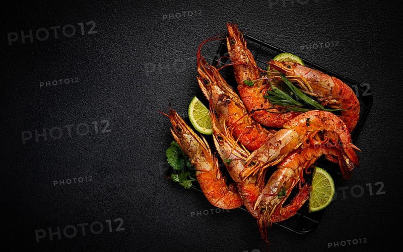 Langoustines, Australian, freshly frozen on ice, top view, lime and greens