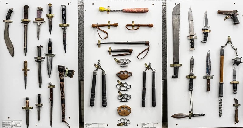 Prohibited weapons seized by the police, cutting and stabbing weapons, knives, machetes, switchblades, brass knuckles, batons, a representation of the police