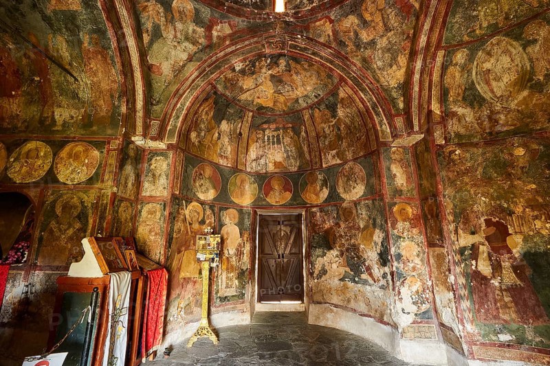 An ancient church with walls covered in frescoes and a central wooden door, Byzantine Chapel of Agios Nikolaos Foundoukli, between Eleousa and Profitis Ilias, Rhodes, Dodecanese, Greek Islands, Greece, Europe