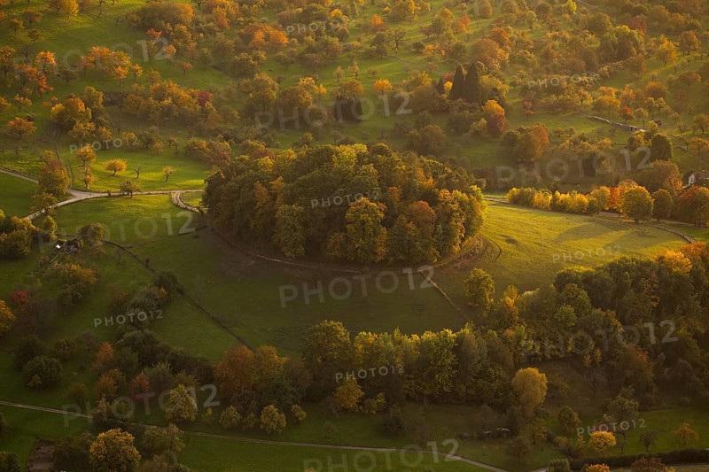 Volcanic embryo Hohbölle near Beuren. Autumnal Swabian Alb at sunset