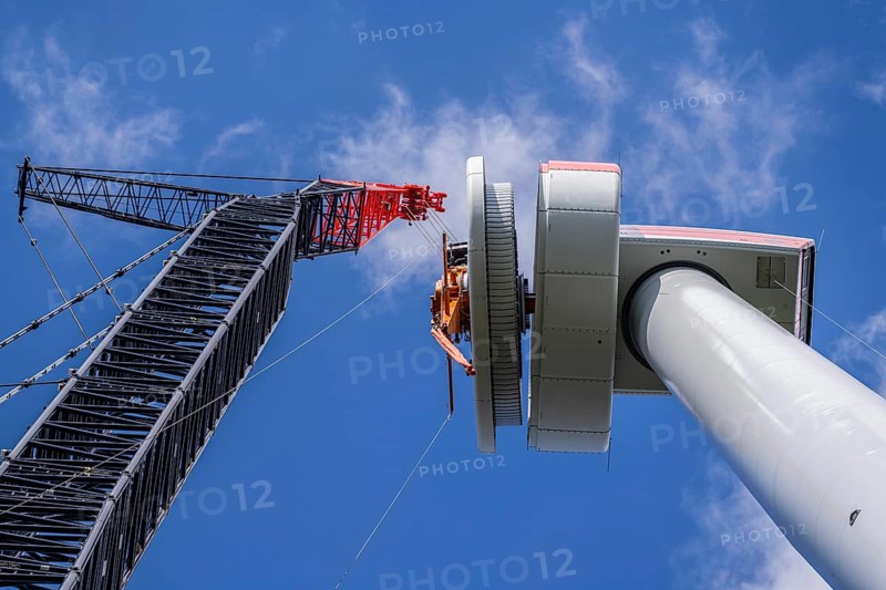 Erection of a wind turbine, wind energy plant, assembly of the ring generator, with a crawler lattice crane, wind farm near Hagen, North Rhine-Westphalia, Germany, Europe