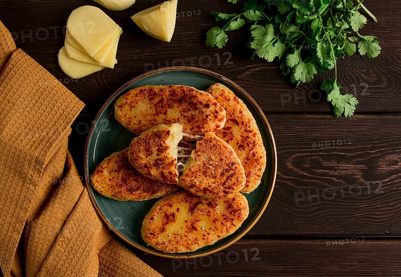 Chvishtari, corn flour tortillas with cheese, pastries, Georgian cuisine, Mchadi, homemade, top view, on a wooden table, no people