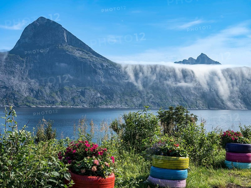 View from rest area over fjord Mefjord on Senja island, in the background the peaks of famous Segla mountain and Mt. Grytetippen, Norway, Europe