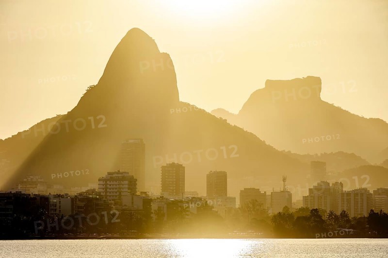 Sunset at the Rodrigo de Freitas lagoon in the city of Rio de Janeiro with the Gavea stone and Two Brothers hill, Brasil