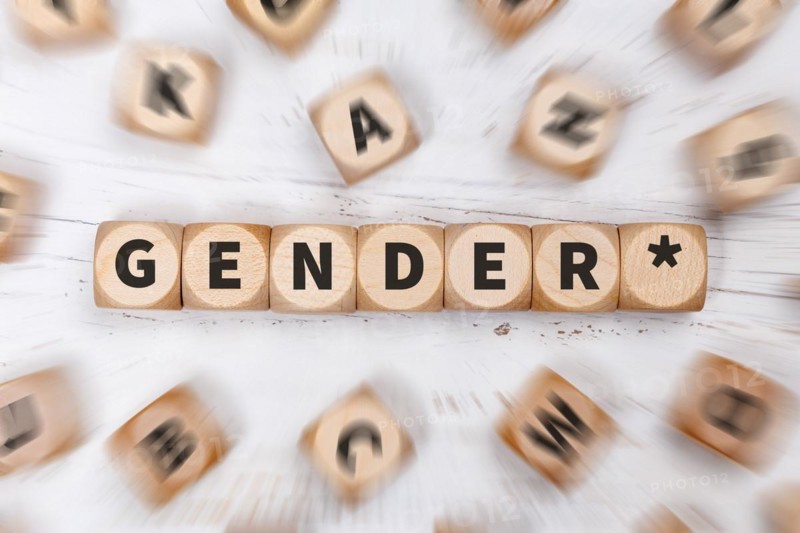 Gendering with gender stars as a symbol for gender-appropriate language on dice Communication concept in