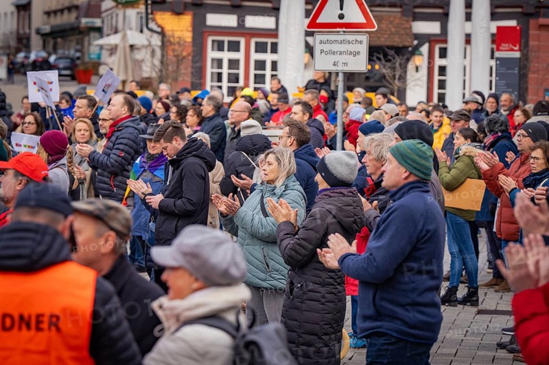 Group of people applauding at an event with security service in the foreground, Against the Right Demo, Nagold, Black Forest, Germany, Europe