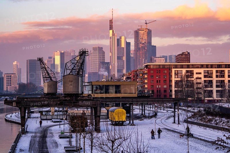 The skyline of Frankfurt am Main, skyscrapers of the banking district, historic harbour cranes at the Wesel shipyard, wintry morning, Hesse, Germany, Europe