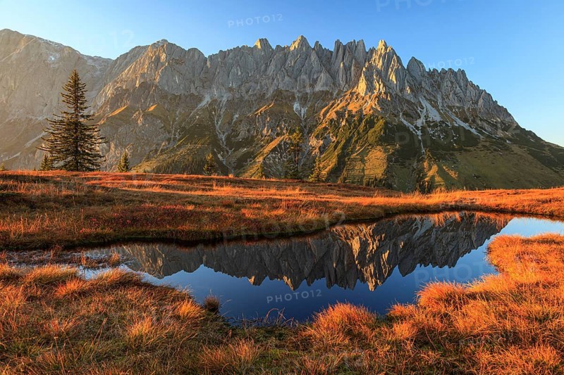 Rugged mountains reflected in a small mountain lake, autumn, evening light, Hochkönig, Mandlwand, Maria Alm, Tyrol, Austria, Europe