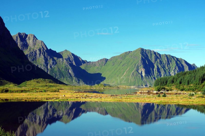 Mountains reflected in the water of an inlet, Leknes, Vestvagoy, Lofoten, Nordland, Norway, Europe