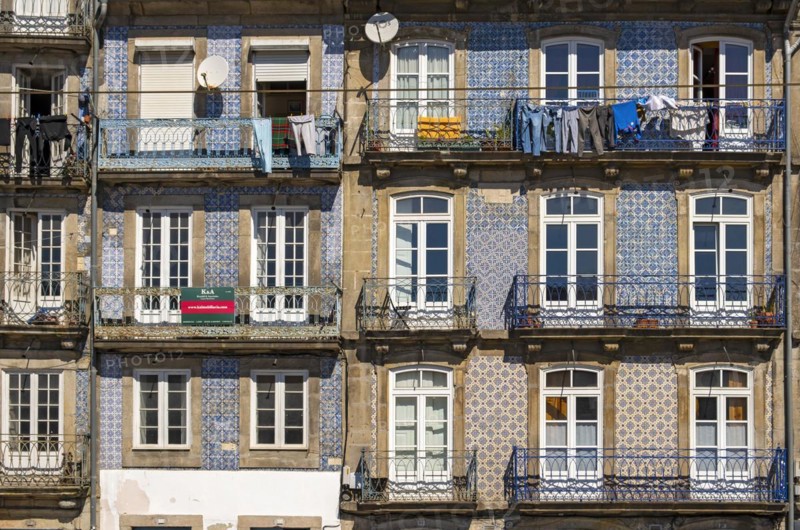 Front facades of narrow houses in the historic center near the Douro river in Porto, Portugal, Europe