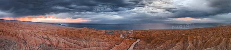 Panorama, landscape of eroded hills, badlands at sunset, Issyk Kul Lake in the background, aerial view, Canyon of the Forgotten Rivers, Issyk Kul, Kyrgyzstan, Asia