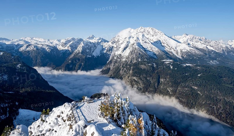 Tourist with camera on a hiking trail, Snow-covered summit of the Jenner with viewing platform in autumn, view of the sea of clouds and Watzmann, Berchtesgaden National Park, Berchtesgaden Alps, Schönau am Königssee, Berchtesgadener Land, Bavaria, Germany, Europe