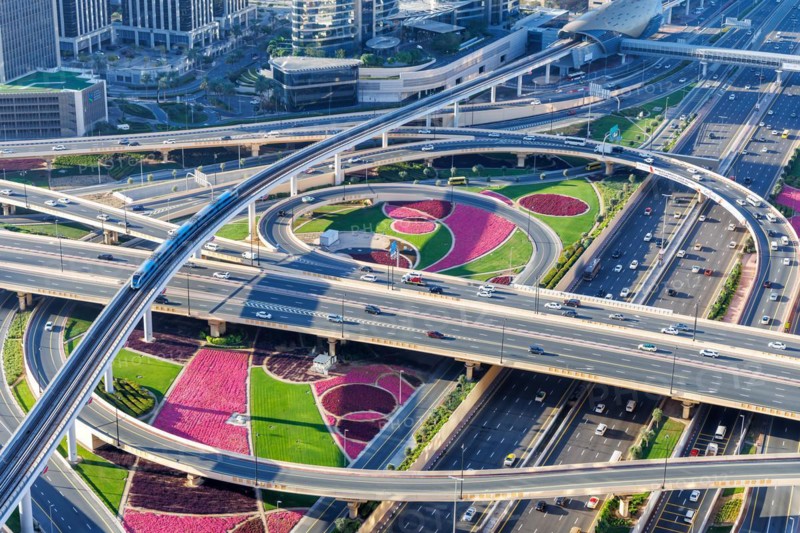 Intersection of Sheikh Zayed Road traffic on the road near the Burj Khalifa with Metro in Dubai, United Arab Emirates, Asia