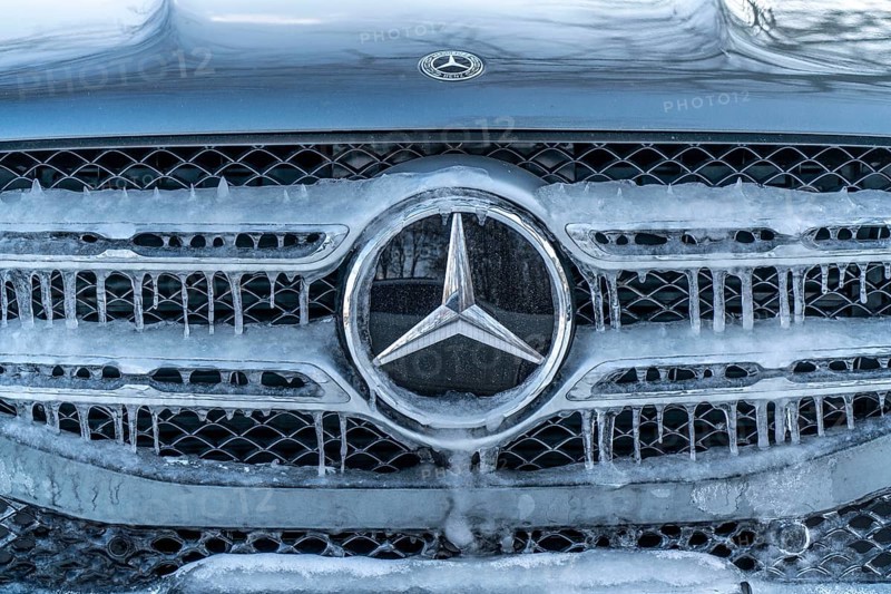 Winter weather, radiator of a vehicle with icicles