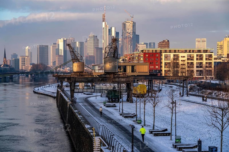 The skyline of Frankfurt am Main, skyscrapers of the banking district, historic harbour cranes at the Wesel shipyard, wintry morning, Hesse, Germany, Europe