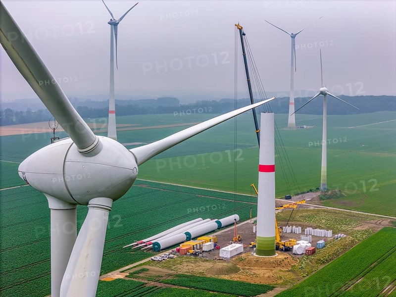 Erection of the tower of a wind power plant in a wind farm near Issum, 9 older wind turbines from the manufacturer Enercon (model series E-58) at the rear right and front, which have been in operation for over two decades, will be replaced by a total of four Enercon E-160 turbines, under construction, with a total output of 22 megawatts, Lower Rhine, North Rhine-Westphalia, Germany, Europe
