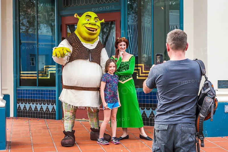 Man photographing daughter with Shrek and Princess Fiona at Universal Studios theme park in Orlando, Florida, USA, North America