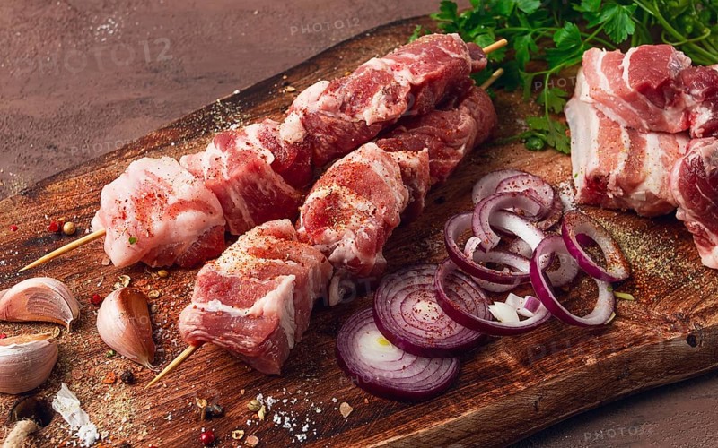 Raw pork meat, on wooden sticks, pickled kebab, with spices, top view, no people