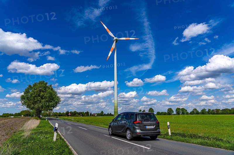 Wind turbine, wind energy plant from the manufacturer Enercon, blue sky with many white clouds, near Schermbeck, country road, Bestener StraÃŸe, North Rhine-Westphalia, Germany, Europe