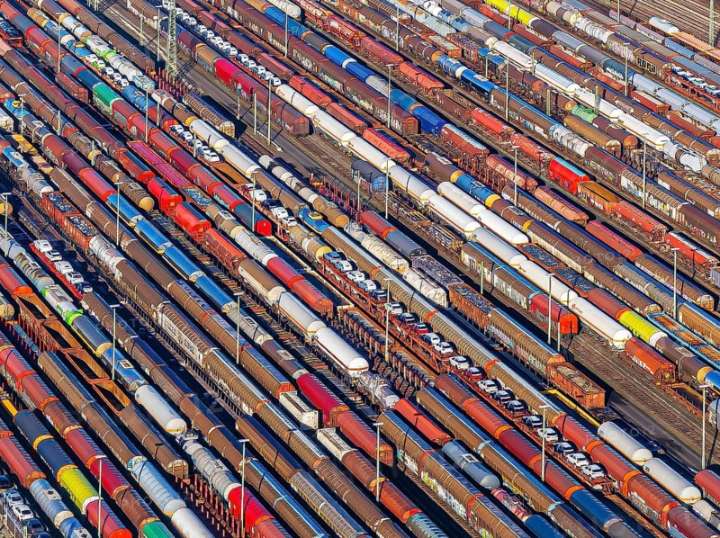 Deutsche Bahn AG marshalling yard. Many goods trains are parked on the tracks with tank wagons, car transporters and other wagons, companies transport a considerable part of their freight by rail, aerial view, Germany, Europe