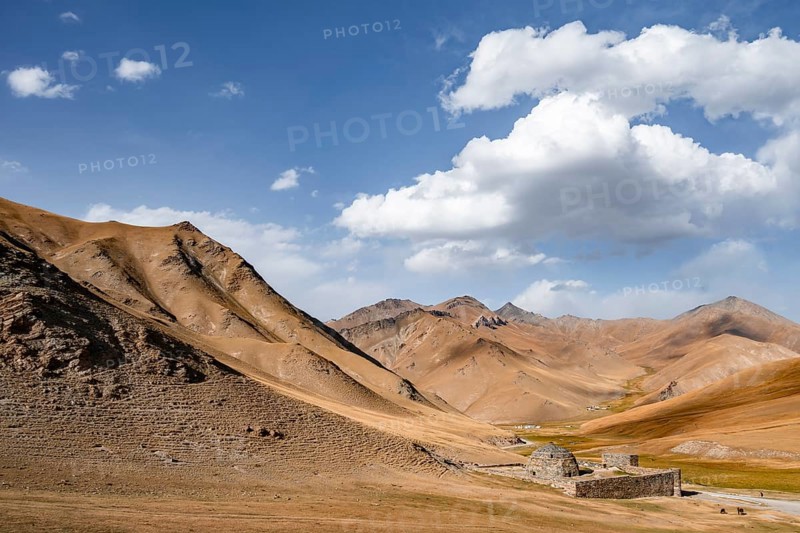 Historic caravanserai Tash Rabat from the 15th century, with yellow hills, Atbashy district in the Naryn region, Kyrgyzstan, Asia