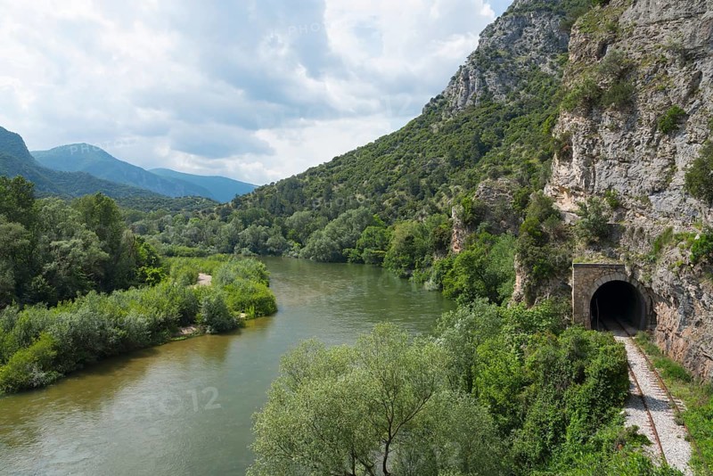 Natural riverbank at the foot of an impressive rock face under a cloudy sky, railway tunnel, Nestos or Mesta River, Nestos Gorge, Galani, Macedonia and Thrace, Greece, Europe