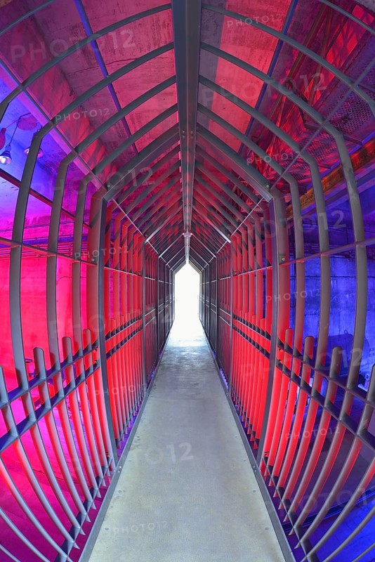 A long tunnel with red lighting and metallic structures conveys a futuristic and industrial atmosphere, Landschaftspark Duisburg Nord, Meiderich Hütte, Duisburg, Ruhr area, North Rhine-Westphalia, Germany, Europe