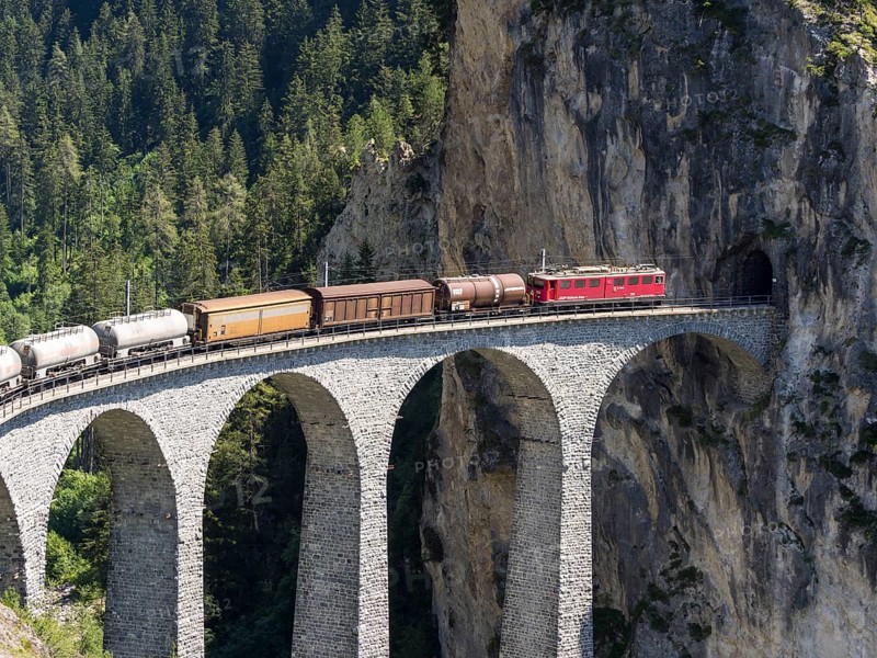 Freigth train passing the Landwasserviadukt near Filisur, Switzerland, Europe