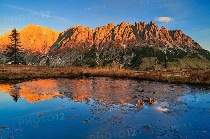 Autumnal alpine pasture at sunrise, alpenglow, frozen water with reflection, Hochkönig, Hochkeil, Mühlbach am Hochkönig, Pongau, Salzburg, Austria, Europe