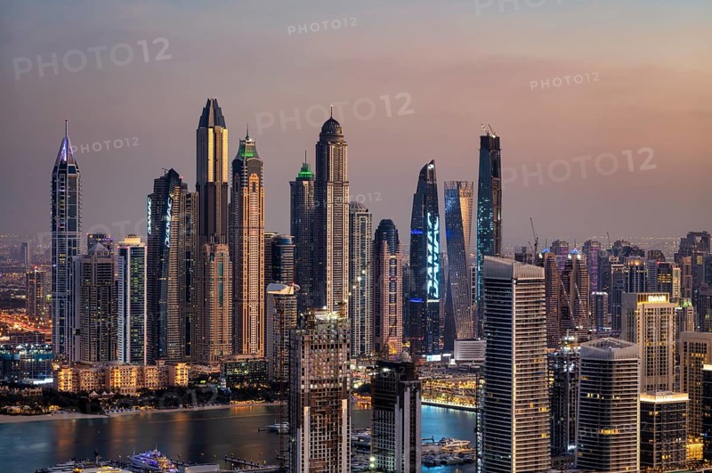 View of the skyline with Princess Tower, Elite Residence, luxury yacht OPERA owned by Sheikh Mansour bin Zayed Al Nahyan from the ruling family of the Emirate of Dubai, anchored in front of EMAAR Beachfront, Logo, DAMAC, evening mood, Dubai Marina, Dubai, United Arab Emirates, VAR, Asia