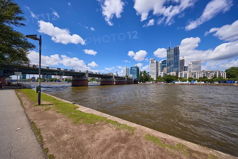 Untermainbrücke with riverside promenade, Main and skyscrapers under a blue sky with cumulus clouds in Frankfurt am Main, Hesse, Germany, Europe